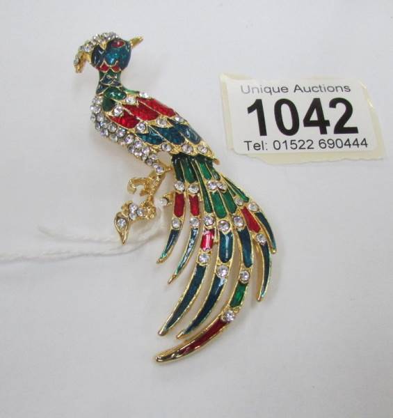A lovely jewelled peacock brooch