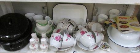 A shelf of assorted teaware,