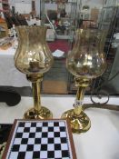 A pair of brass candle lamps