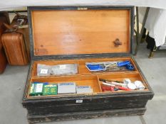 A wooden tool box and contents