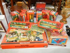 A collection of boxed Britain's farm toys