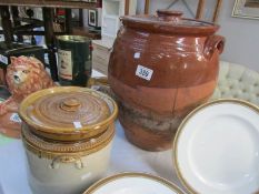 A stoneware lidded storage jar and one other