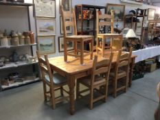 A pine table with 6 chairs