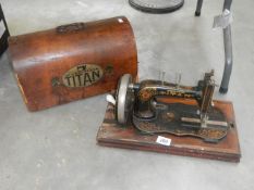 A vintage Winselmann Titan sewing machine with cover