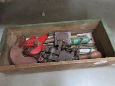 A box of tools including vice, hand grinder,