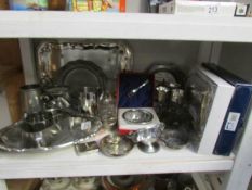 A shelf of assorted silver plate including trays, tankards, wedding gift set etc.