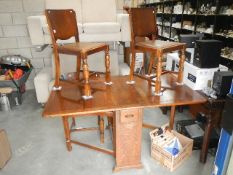 A draw leaf table and 4 chairs