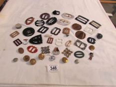 A mixed lot of vintage buckles, buttons, brooches etc.