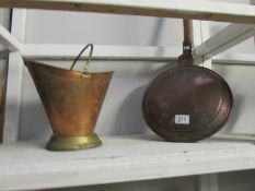 A Victorian copper warming pan and a small coal scuttle