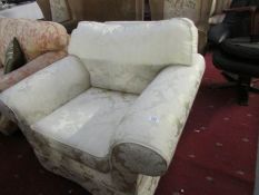 A cream brocade arm chair