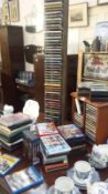 A large quantity of CD's, DVD's, Blu-Rays and 2 CD shelves