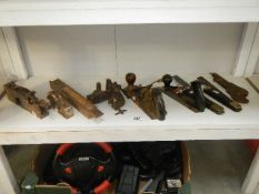 A shelf of tools including wood working planes