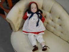 A porcelain headed doll (markings to neck)