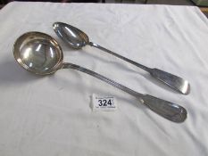 A large silver plated ladle and serving spoon