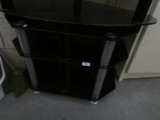 A black glass TV stand