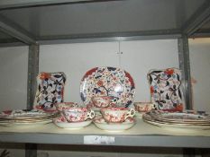 A shelf of oriental style table ware