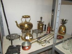 A shelf of assorted brass ware including paraffin lamp