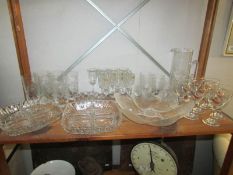 A shelf of assorted glass ware