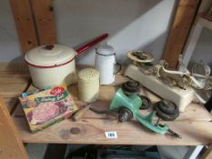 A shelf of vintage kitchenalia including scales, enamel ware etc.