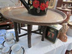 A brass tray topped table