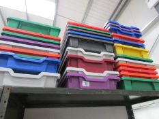 A quantity of plastic storage trays