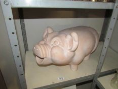 A large terracotta pig