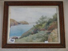 A framed and glazed watercolour of a river scene signed J.