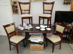 A mahogany dining table and 4 chairs