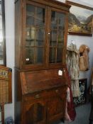 An oak bureau book case