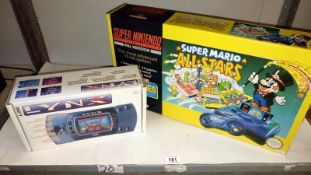 A boxed Atari Lynx portable colour system (no power lead) a boxed Super Mario All Stars Super