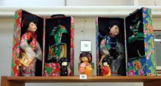 2 new and boxed Chinese style porcelain dolls and 3 other oriental style dolls