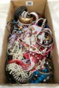 A box of costume jewellery including necklaces