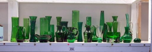 A large quantity of green glass items