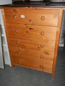 A 5 drawer pine chest of drawers