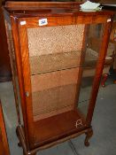 A 1950s single door glass cabinet