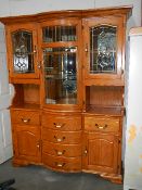 A fine oak bow front cabinet