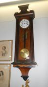 A twin weight Vienna wall clock with weights,