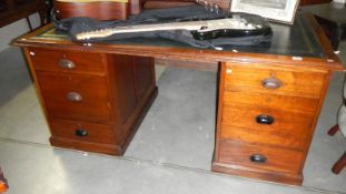 A twin pedestal mahogany desk with leather top