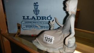 A Lladro figure of Girl seated with Bird in original box