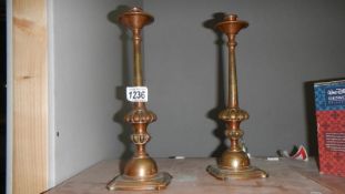 A good pair of Georgian brass candlesticks with a copper plated finish