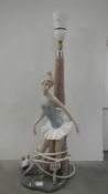 A large NAO figural table lamp of a girl