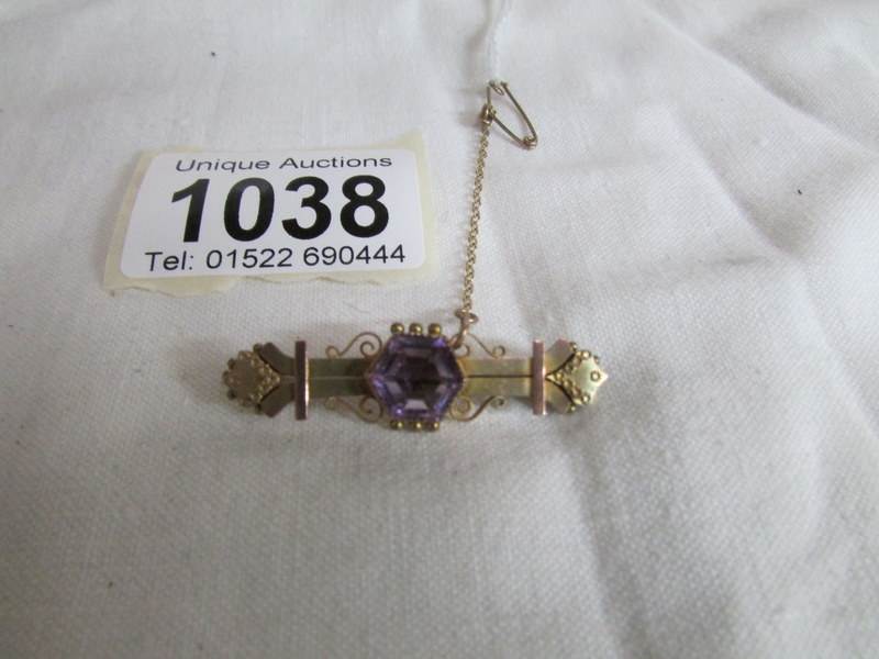 A Victorian gold bar brooch set amethyst