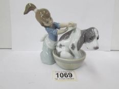 A Lladro figure of a girl bathing her dog