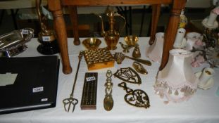 A mixed lot of brassware including cribbage board