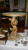 A figural table with round top