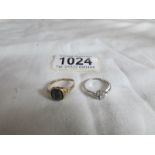A white gold 7 stone diamond ring size I and a black onyx yellow gold ring size L