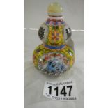 An unusual overpainted perfume bottle