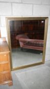 A large bevel edged mirror in gilt frame