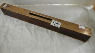 A heavy brass and hardwood spirit level inscribed J Teal 1947