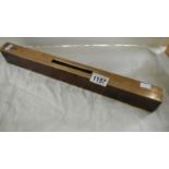 A heavy brass and hardwood spirit level inscribed J Teal 1947